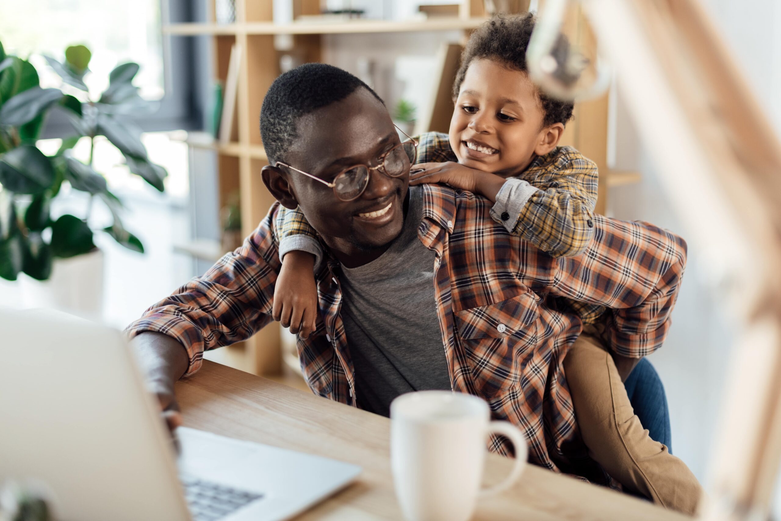 Man and son enjoying time together while working from home