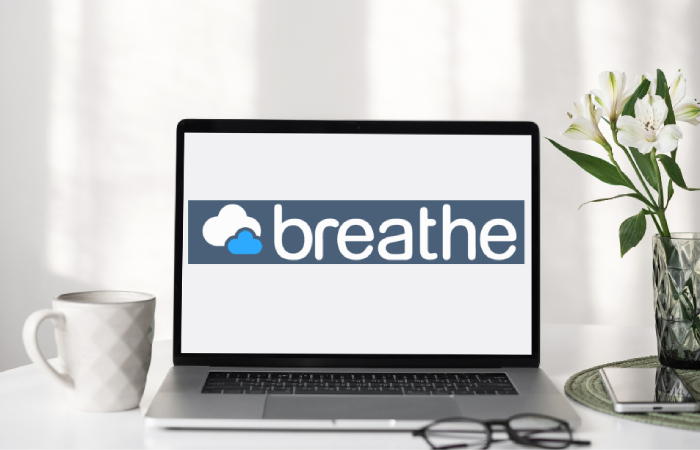 Image of Breathe HR on laptop screen on table with cup of tea next to it