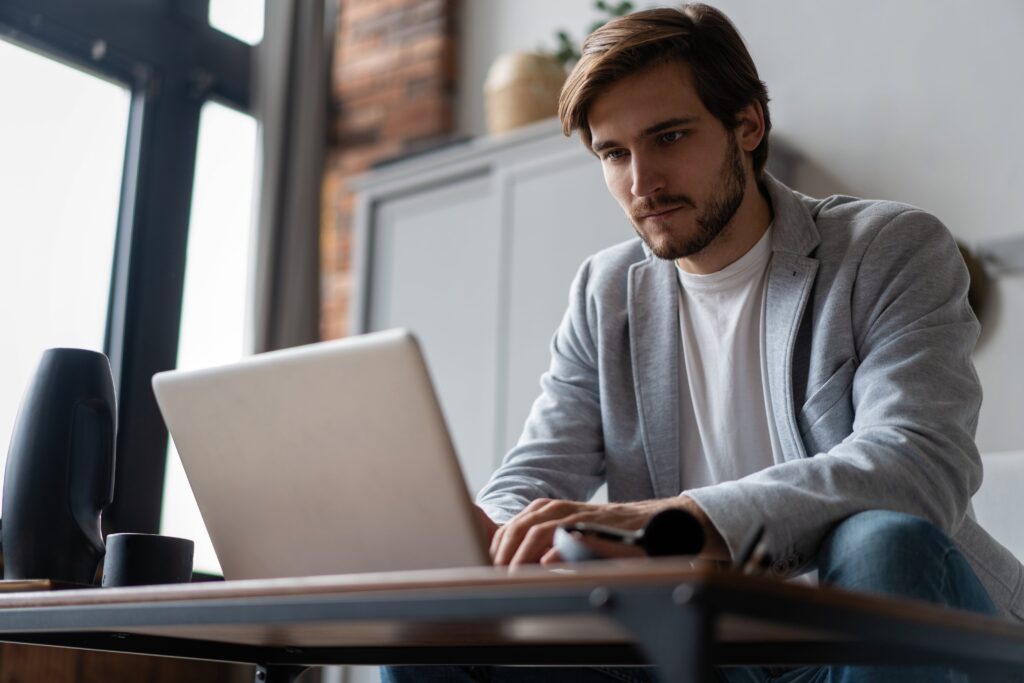 Image of man looking at laptop, using Breathe HR