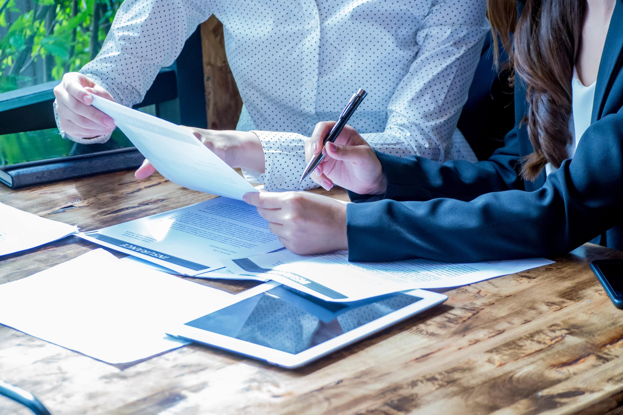 HR Support for small businesses with two female office workers discussing report